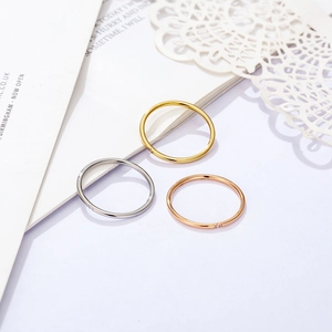 Detailed view of minimalist gold, silver, and rose gold rings with cubic zirconia stones