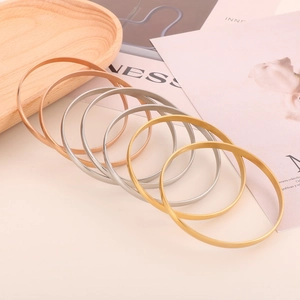 Detailed stack of minimalist titanium steel bangles in gold, silver and rose gold finish