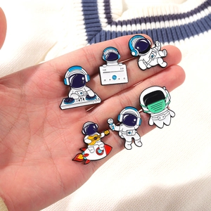 Set of six colorful enamel astronaut pins featuring space themes and musical designs