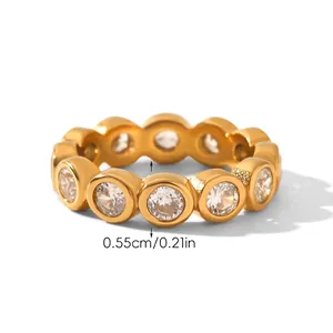 Close-up of gold eternity ring with circular zircons, measuring 0.55cm in width