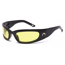 Macro view of Y2K sports goggles featuring thick black frames and yellow tinted lenses