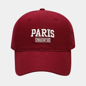 Detailed embroidery of PARIS letters on a burgundy soft cotton baseball cap crown