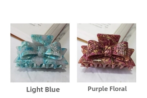 Detail of cellulose acetate bow hair clips with rhinestones in blue and purple marble