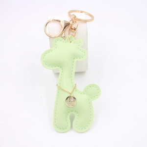 Close-up of light green PU leather giraffe keychain with gold lobster clasp and rhinestones