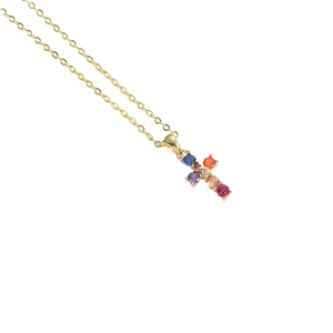 Minimalist gold necklace with a cross pendant featuring multi-colored gemstones in white background