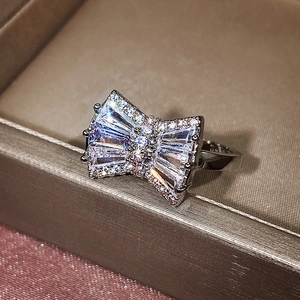 Macro shot of a silver bow ring with sparkling zircons set in a premium jewelry box