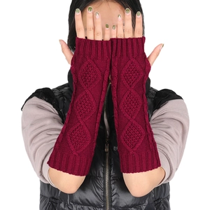 Close-up of diamond pattern knit texture on deep red long fingerless arm warmers