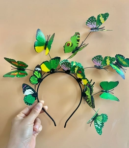 Detail shot of multi-layered green 3D butterfly headbands for Christmas party styling