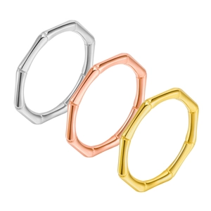 Detailed close-up showing three polished bamboo-style rings in gold, silver, and rose gold