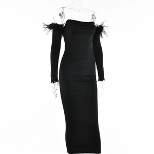 Detailed view of black off-the-shoulder dress with elegant feather trim on shoulders