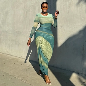 Detail of green and light brown tie-dye dress featuring side ruching and slim fit