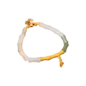Elegant bamboo leaf charm bracelet featuring gold metal and pale green jade beads