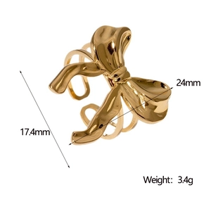 Detail view of golden bow ring with dimensions 24mm width and 17.4mm diameter
