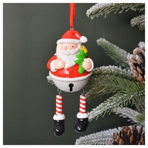 Festive Santa Claus metal bell ornament hanging on a Christmas tree branch with red ribbon