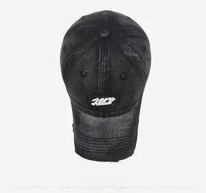 Top view of washed black denim baseball cap with Zero embroidery and distressed brim