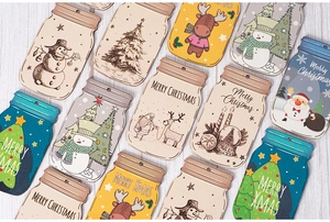 Detailed view of mason jar shaped wooden Christmas tags with festive holiday patterns