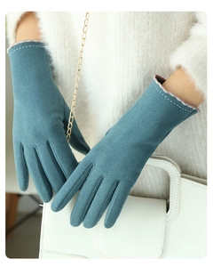 Close-up of cyan faux suede gloves for women with elegant white decorative stitching