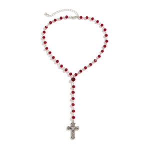 Detailed view of red crystal rosary beads with ornate silver cross pendant on white background