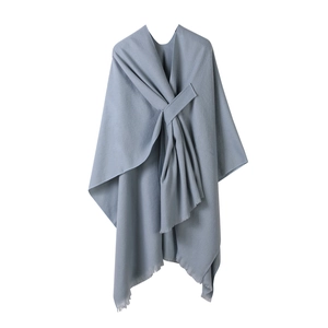 Light blue solid color poncho shawl with knot detail and tassel trim for winter warmth