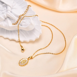 Golden necklace with oval Virgin Mary pendant featuring white mother of pearl inlay