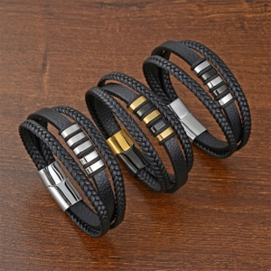 Detail of multi-layer braided leather bracelets with gold and silver magnetic clasps