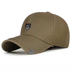 Detail view of khaki baseball cap with Dinghan shield embroidery and twill cotton texture