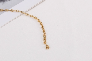 Detailed close-up of golden geometric chain links with polished minimalist finish