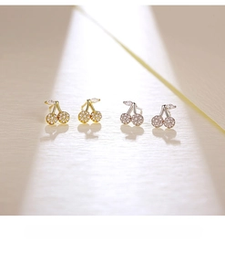 Macro shot of 925 silver cherry earrings with micro-paved cubic zirconia detail
