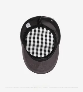 Detail view of cotton flat top cap showing black and white checkered lining and wash label