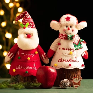Plush Santa and Snowman Christmas figurines on wooden bases with festive holiday decor