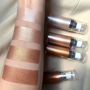 Arm swatches and four-color set of shimmering liquid body highlighters with pump