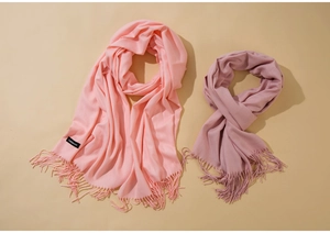 Detailed texture of pink and purple cashmere scarves with fine fringe tassels