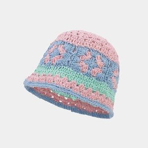 Detail of handmade crochet bucket hat featuring hollow floral patterns and pastel colors
