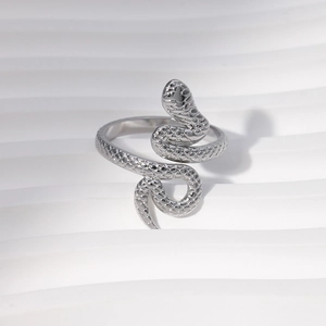 Macro shot of silver snake ring showing detailed scales on a white wave background