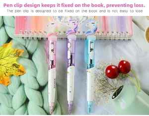 Close-up of unicorn light-up pens with pastel colors on a cozy desk setup