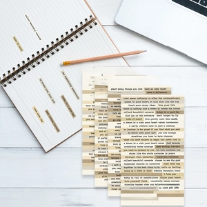 Detailed view of vintage typography quote stickers for journaling on a wooden desk