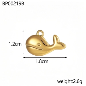 Detailed view of a golden whale pendant with dimensions 1.2cm by 1.8cm and 2.6g weight