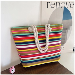 Close-up of colorful striped canvas tote bag with thick natural hemp rope handles