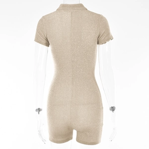 Rear view detail of beige short sleeve romper with subtle glitter texture on a mannequin