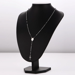 Retro hip-hop beaded chain necklace with cross pendant on a black bust display