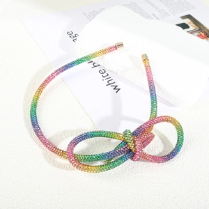 Rainbow rhinestone headband with sparkly knotted bow and gold metal tips for women