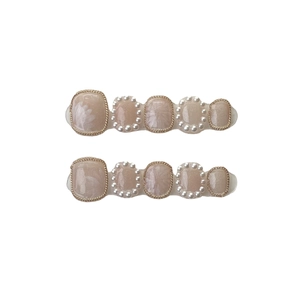 Handmade pearlescent nude pink toe press-on nails with gold chains and pearl accents