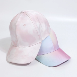 Detail showing two tie-dye and gradient satin baseball caps with structured curved brims
