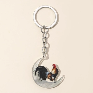 Close-up of crescent acrylic pendant featuring a colorful rooster print on silver keychain