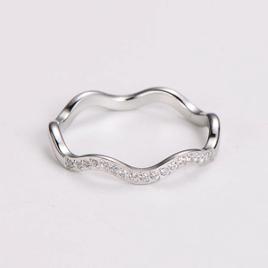 Close-up of silver wavy ring with micro-pave crystals and polished finish detail