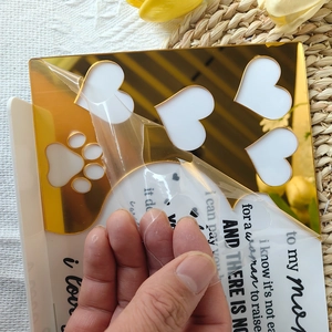 Peeling protection film off gold acrylic heart sign for Mother's Day gift decoration