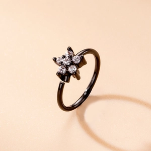 Macro shot of black plated nose ring with sparkling star-shaped micro-pave cubic zirconia
