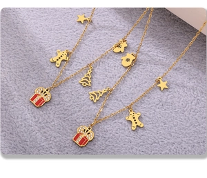 Detail of Christmas charms on a 18K gold-plated stainless steel chain necklace