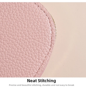 Close-up of pink pebbled leather card holder featuring precision stitching and rounded edges