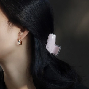 Golden C-shaped hoop earrings with square zircon and pink hair clip on female model